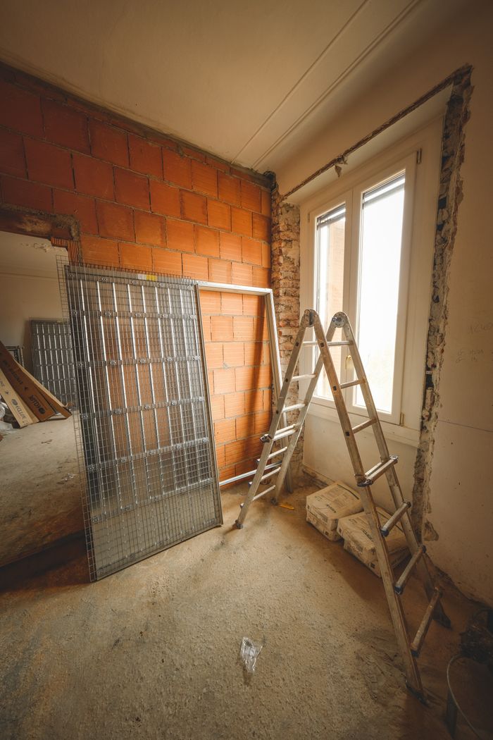 journey-01 An indoor space showing ongoing refurbishment with ladders and construction materials.