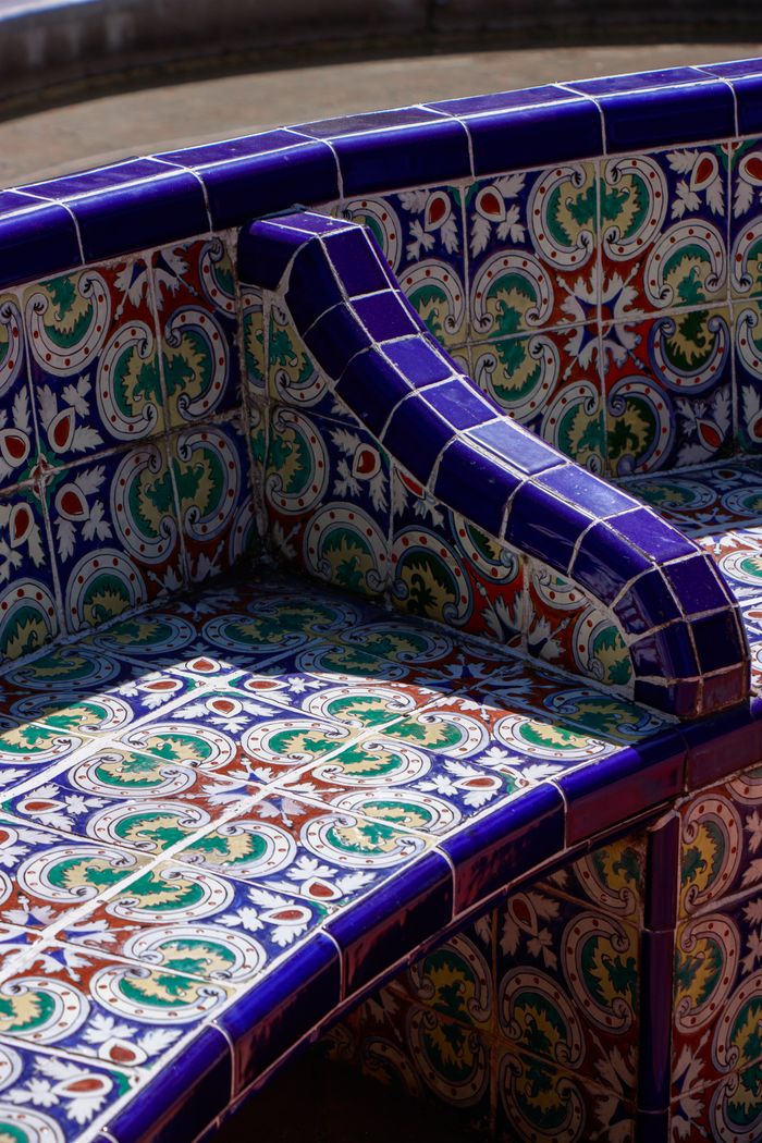services-03 Vibrant mosaic tiled bench showcasing intricate patterns with vivid colors under the sun.