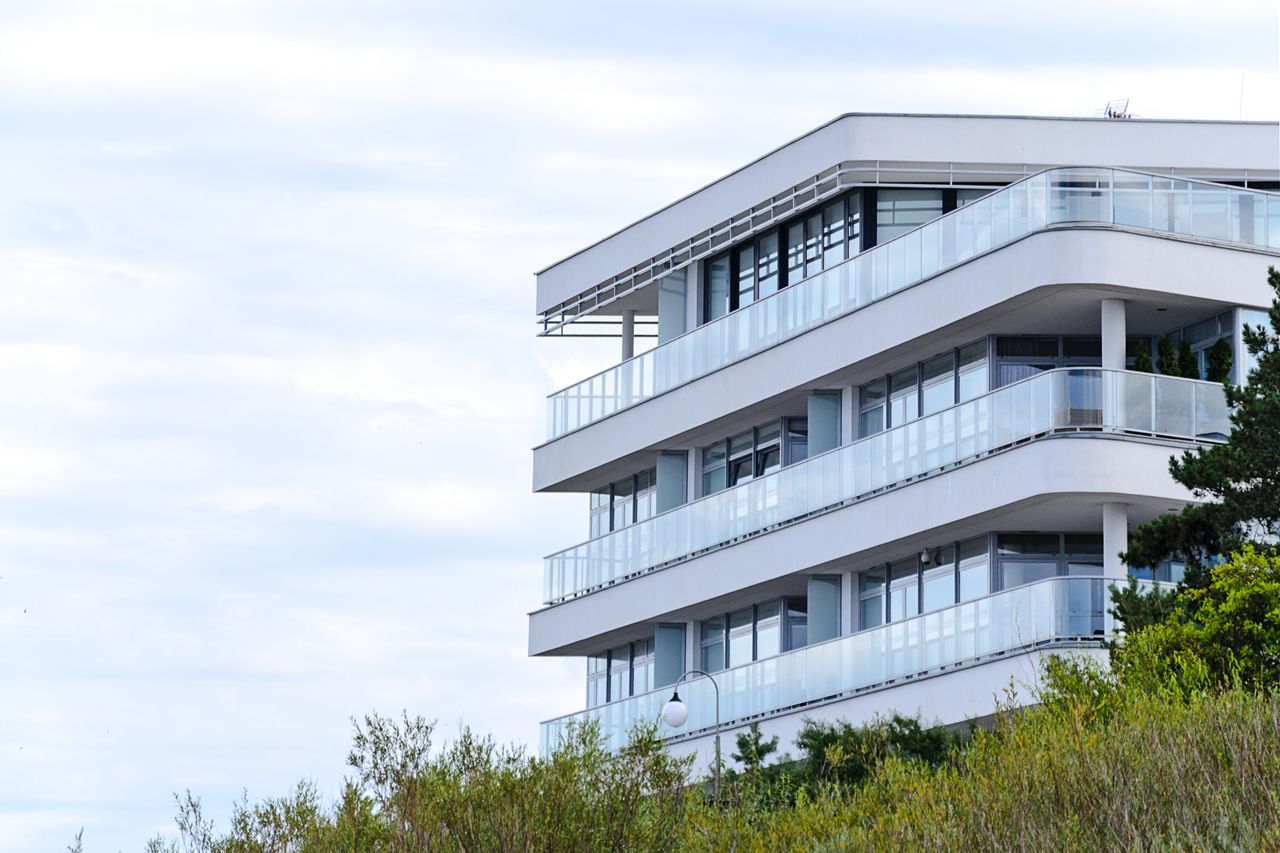 Crafting Captivating Headlines: Your awesome post title goes here A contemporary apartment building with glass balconies and sleek design set against a clear sky.