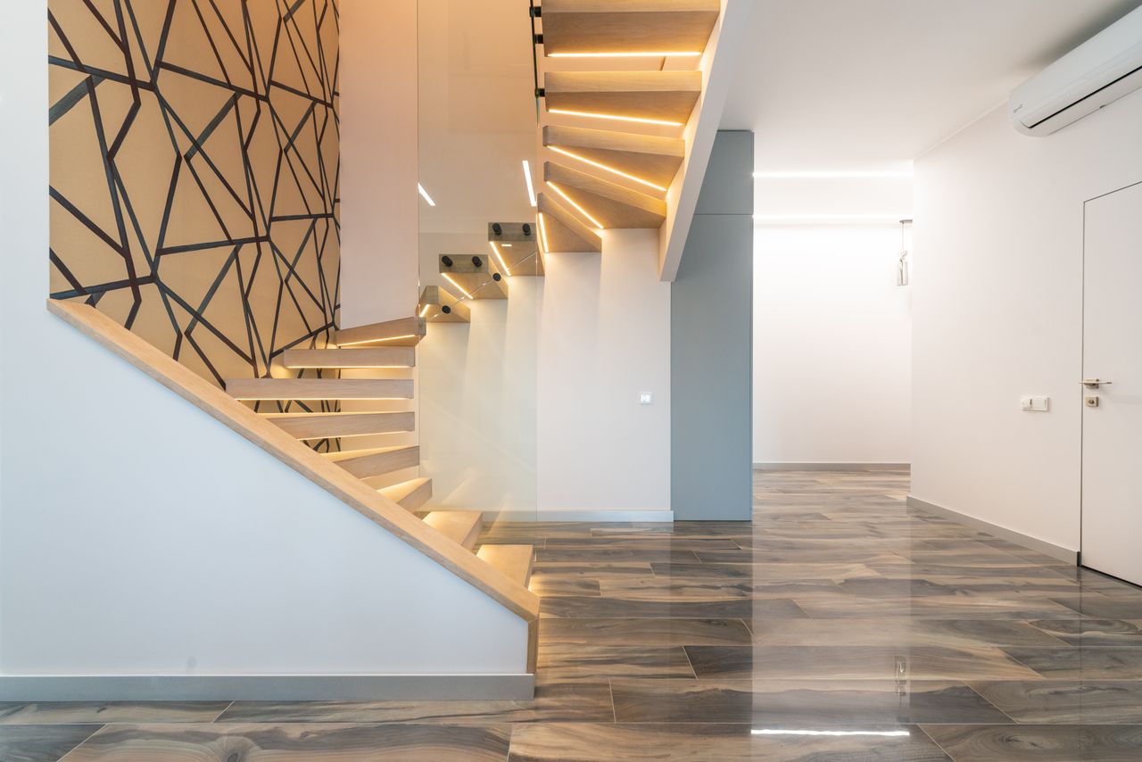 The Art of Drawing Readers In: Your attractive post title goes here Contemporary hall interior with door against curved staircase and wall with geometric ornament in light house
